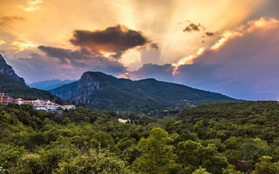 Sunset over Mount Olympus with lush green landscape, viewed from Dion, Greece.
