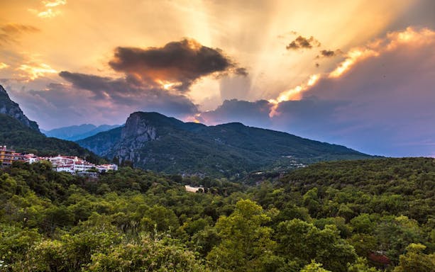 Sunset over Mount Olympus with lush green landscape, viewed from Dion, Greece.