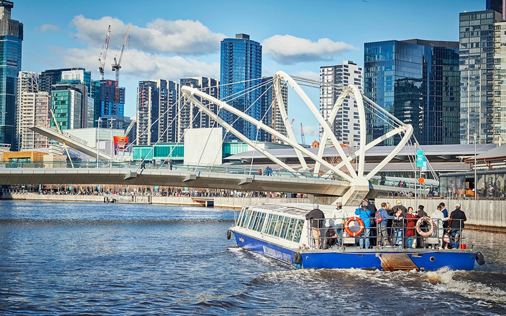 Ferry cruise on Yarra River with Melbourne skyline and Seafarers Bridge in view.