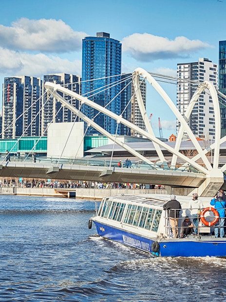 Ferry cruise on Yarra River with Melbourne skyline and Seafarers Bridge in view.