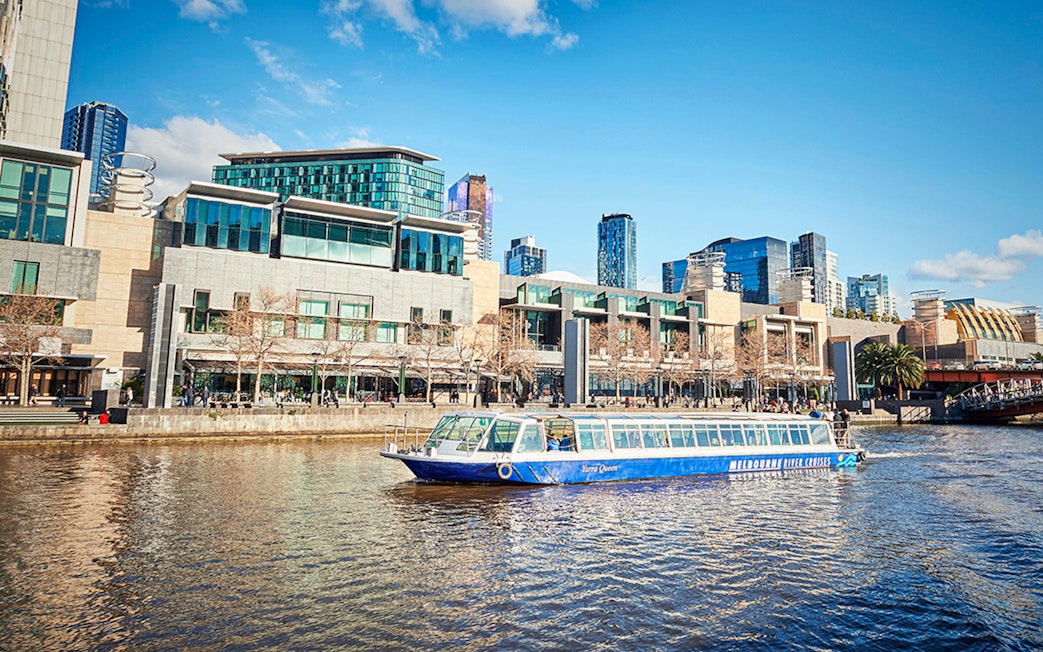 Ferry cruising on the Yarra River with Melbourne cityscape in the background.