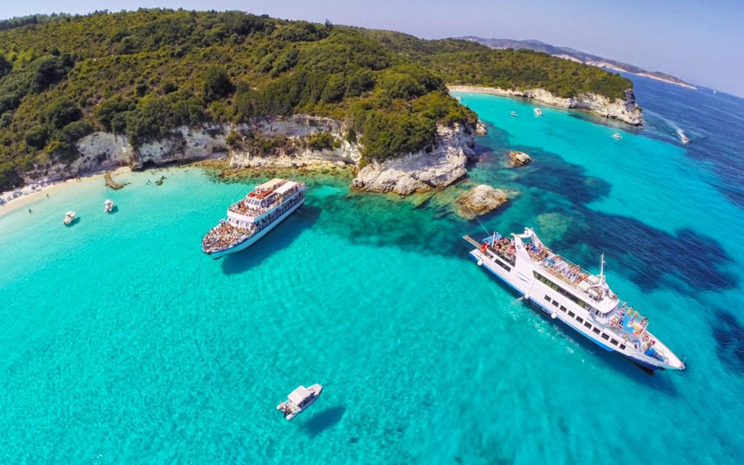 Cruise ships near Paxos and Antipaxos islands with turquoise waters and rocky coastline.