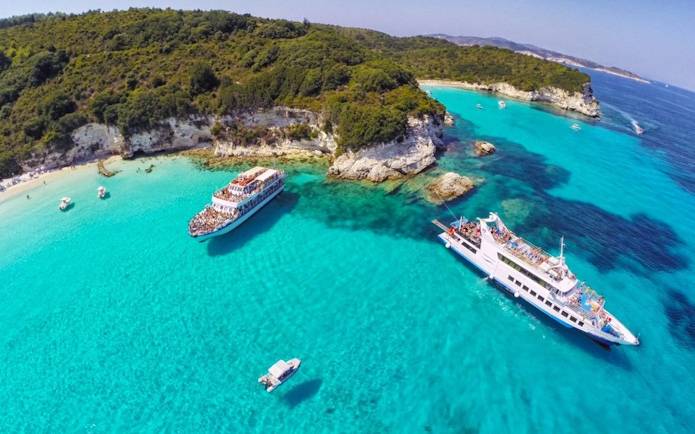 Cruise ships near Paxos and Antipaxos islands with turquoise waters and rocky coastline.