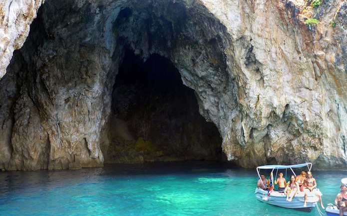 Boat entering sea cave on Blue Lagoon & Sivota cruise from Corfu.