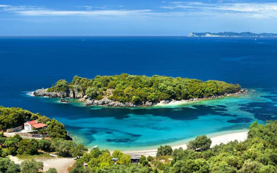 Blue Lagoon with lush greenery and clear waters on Sivota cruise from Corfu.
