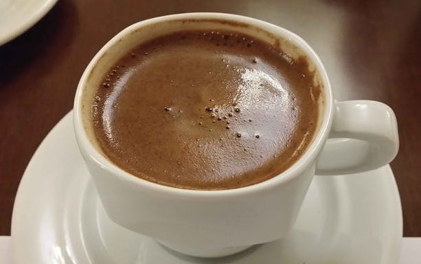Cup of traditional Greek coffee served in Thessaloniki market tour.