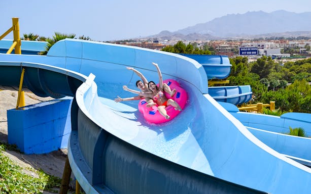 Visitors enjoying a water slide at AquaVera Water Park, Spain.