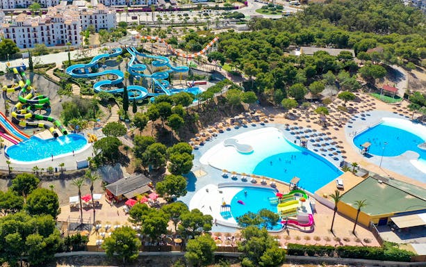 Aerial view of AquaVera Water Park with slides, pools, and sunbathing areas.