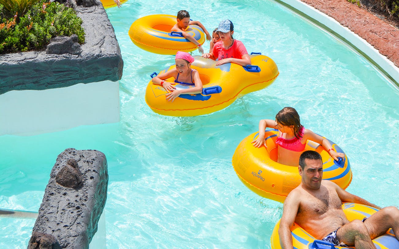 Visitors enjoying the lazy river at Aqualava Water Park, Playa Blanca.