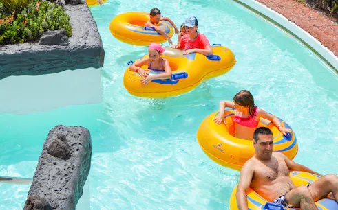 Visitors enjoying the lazy river at Aqualava Water Park, Playa Blanca.