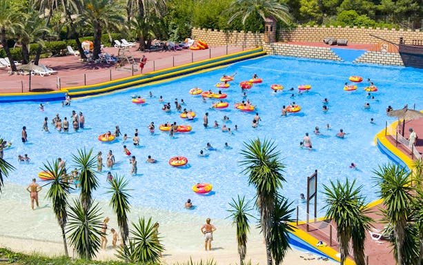 Visitors enjoying the wave pool at Aqualeon Water Park, Tarragona.
