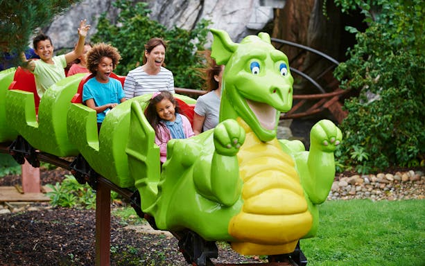 Children enjoying a dragon-themed ride at Legoland New York.
