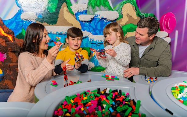 Family building with LEGO bricks at Legoland New York.