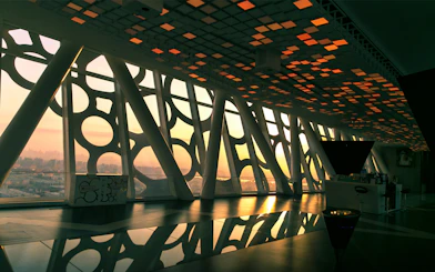 Interior view of Dubai Frame with city skyline at sunset.