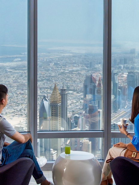 Visitors enjoying the view from Burj Khalifa's observation deck in Dubai.