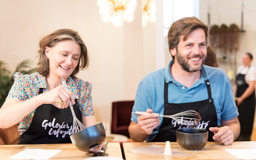 Participants whisking ingredients at Cours de Macarons, Galeries Lafayette.