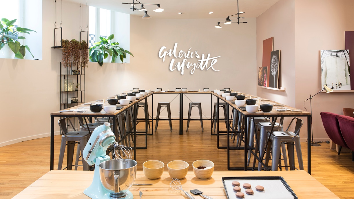 Macaron baking class setup at Galeries Lafayette with mixer and ingredients.