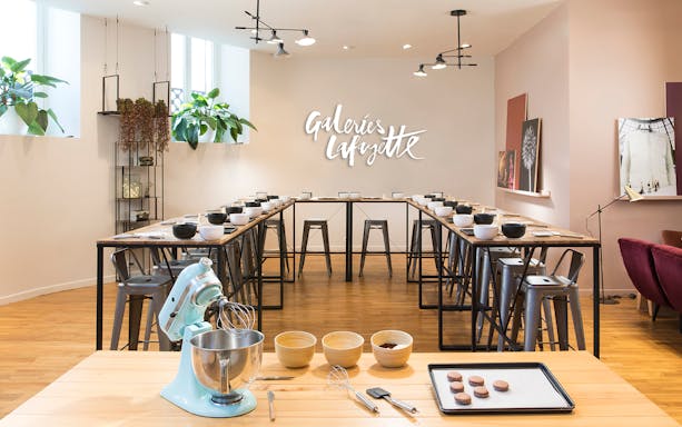Macaron baking class setup at Galeries Lafayette with mixer and ingredients.