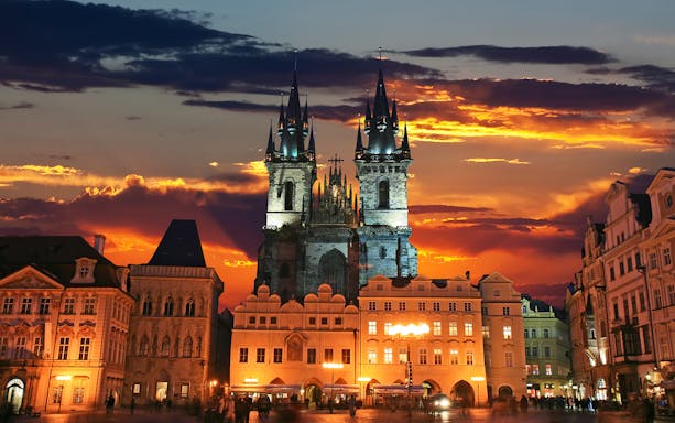 Tyn Church at sunset in Prague's Old Town Square.