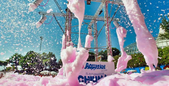 Foam party at Aquafan Water Park with pink foam and blue sky.