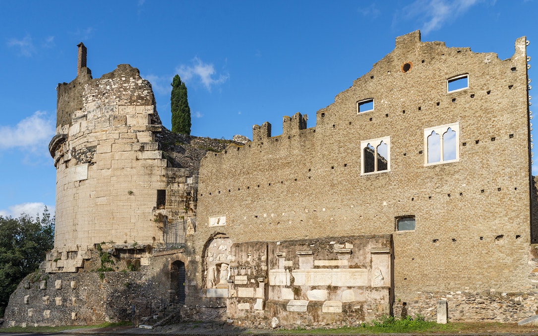 Mausoleum of Augustus ancient stone structure in Rome under blue sky.