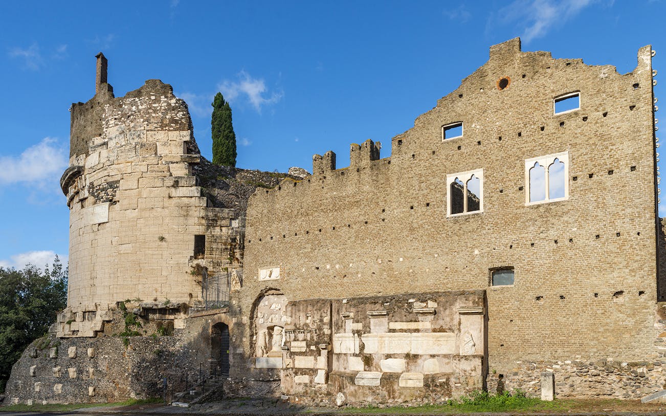 Mausoleum of Augustus ancient stone structure in Rome under blue sky.