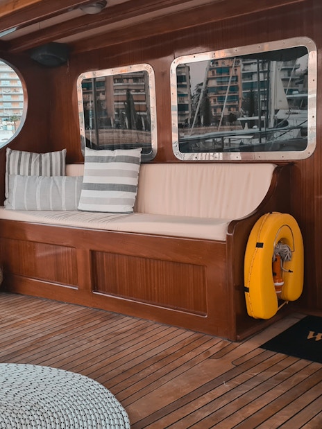 Wooden deck seating area on a cruise ship in Athens marina, Greece.