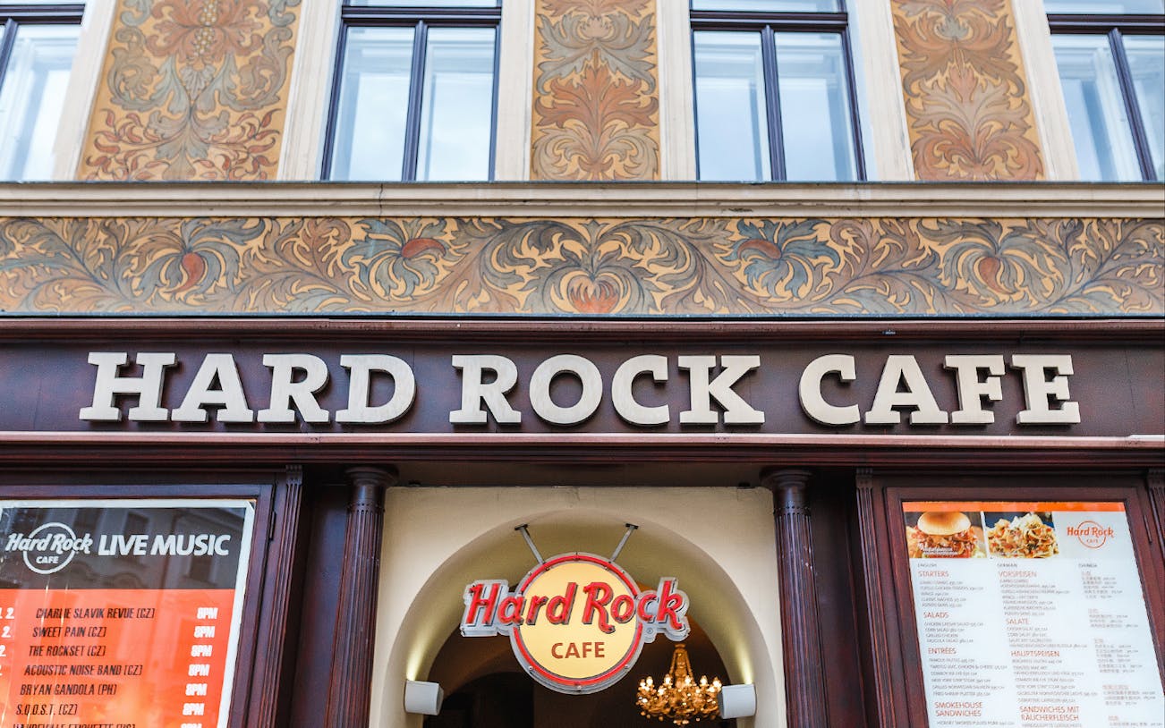 Hard Rock Cafe Prague entrance with menu and live music schedule.