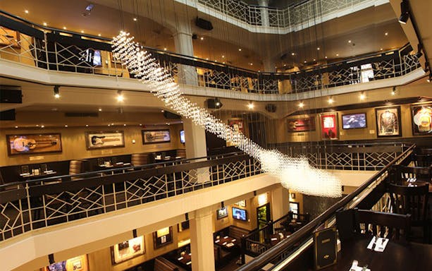 Hard Rock Cafe Prague interior with dining tables and guitar decor.
