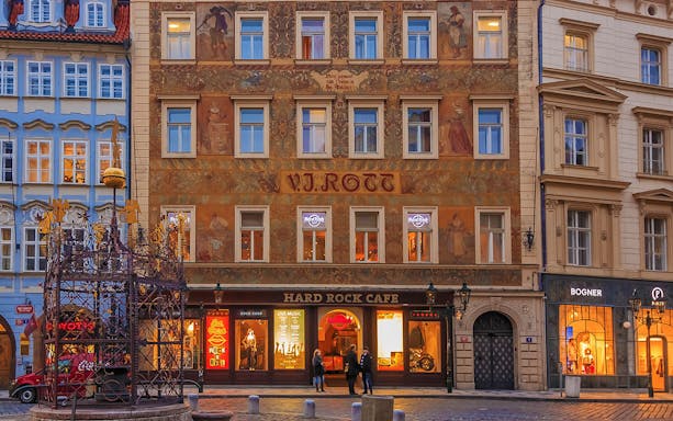 Hard Rock Cafe Prague entrance with illuminated signs and historic building facade.