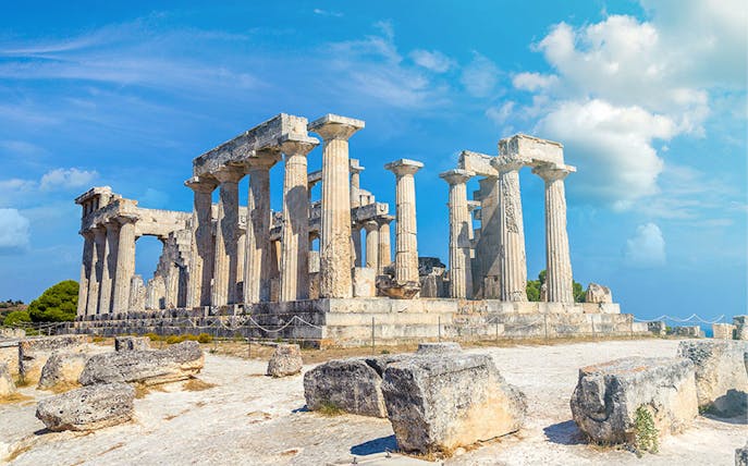 Ancient Temple of Aphaia on Aegina Island, Greece, under a clear blue sky.