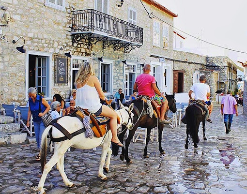 Hydra Island harbor view with docked boats, part of Athens day trip experience.