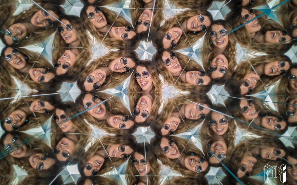 Visitors in kaleidoscope exhibit at Museum of Illusions, Vienna, Austria.