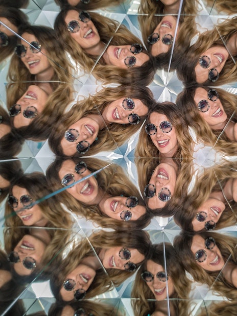 Visitors in kaleidoscope exhibit at Museum of Illusions, Vienna, Austria.