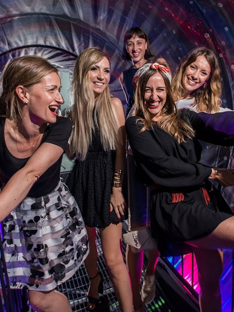 Visitors enjoying interactive exhibits at the Museum of Illusions in Vienna, Austria.