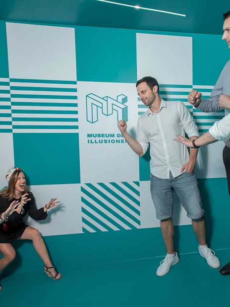 Visitors interacting with exhibits at the Museum of Illusions in Vienna, Austria.