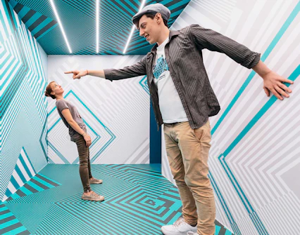 Visitors interacting in an optical illusion room at Museum of Illusions Vienna.