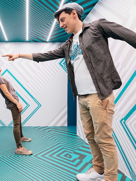 Visitors interacting in an optical illusion room at Museum of Illusions Vienna.