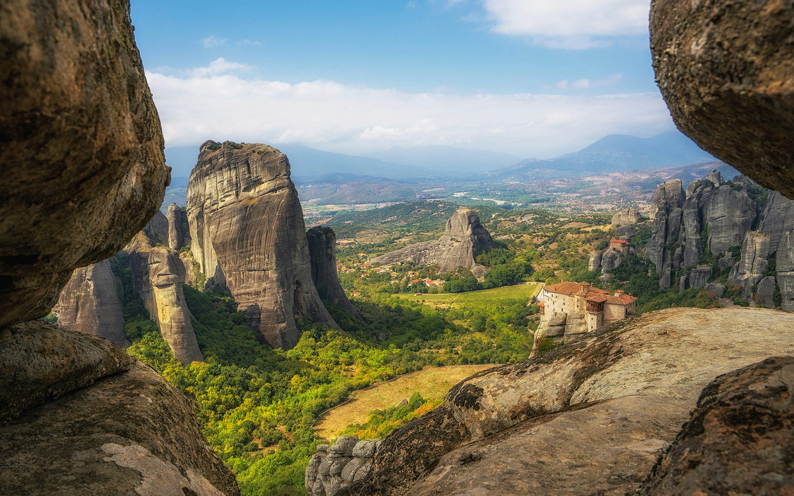 Meteora rock formations and monastery in Greece during morning tour.