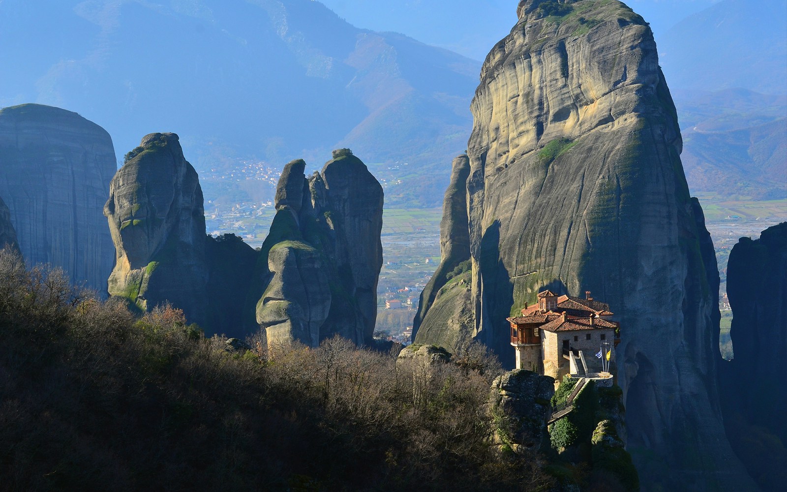 Monastery perched on Meteora rock formations during morning tour in Greece.