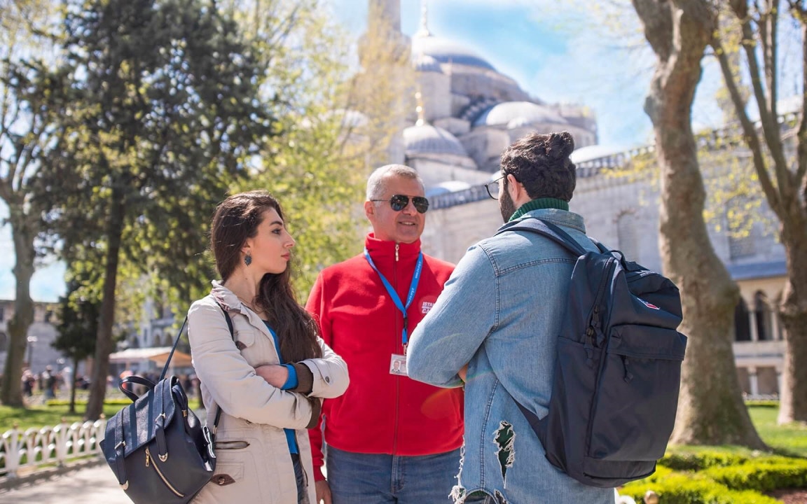 Tour guide with visitors at Blue Mosque, Istanbul, during Combo Tour: Hagia Sophia, Blue Mosque, Topkapi Palace Garden.