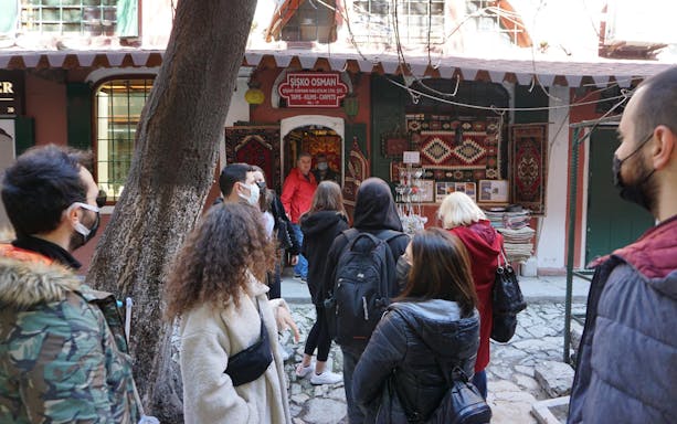 Tour group exploring a carpet shop in Istanbul's Grand Bazaar.