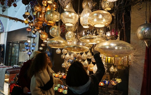Shoppers admire ornate lamps at Istanbul's Grand Bazaar.