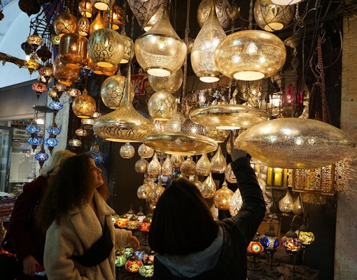 Shoppers admire ornate lamps at Istanbul's Grand Bazaar.