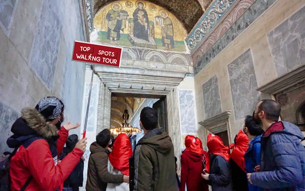 Tour group observing mosaic in historic building on Old City to Taksim walking tour.