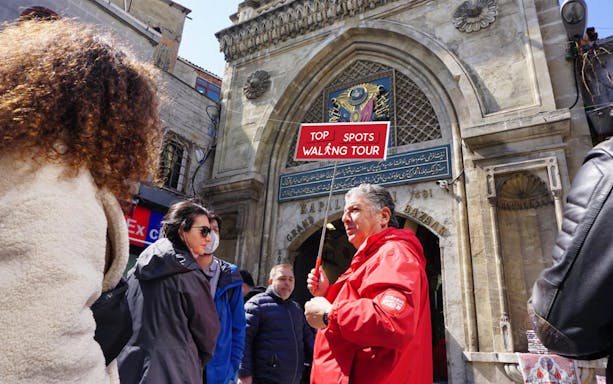 Tour guide leading a group at the entrance of the Grand Bazaar, Istanbul.