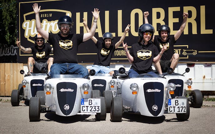 Group enjoying Hot Rod Tour in Berlin with custom mini cars.
