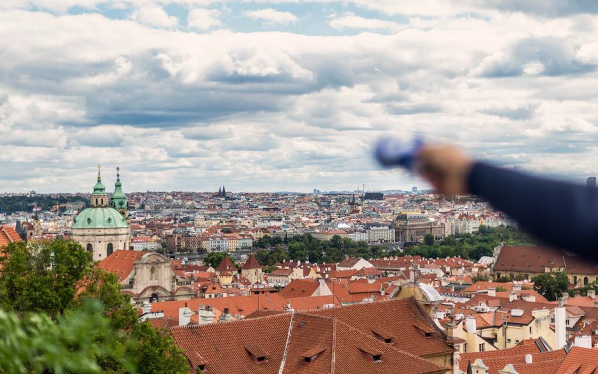 Prague cityscape view with St. Nicholas Church dome during Grand Walking Tour.