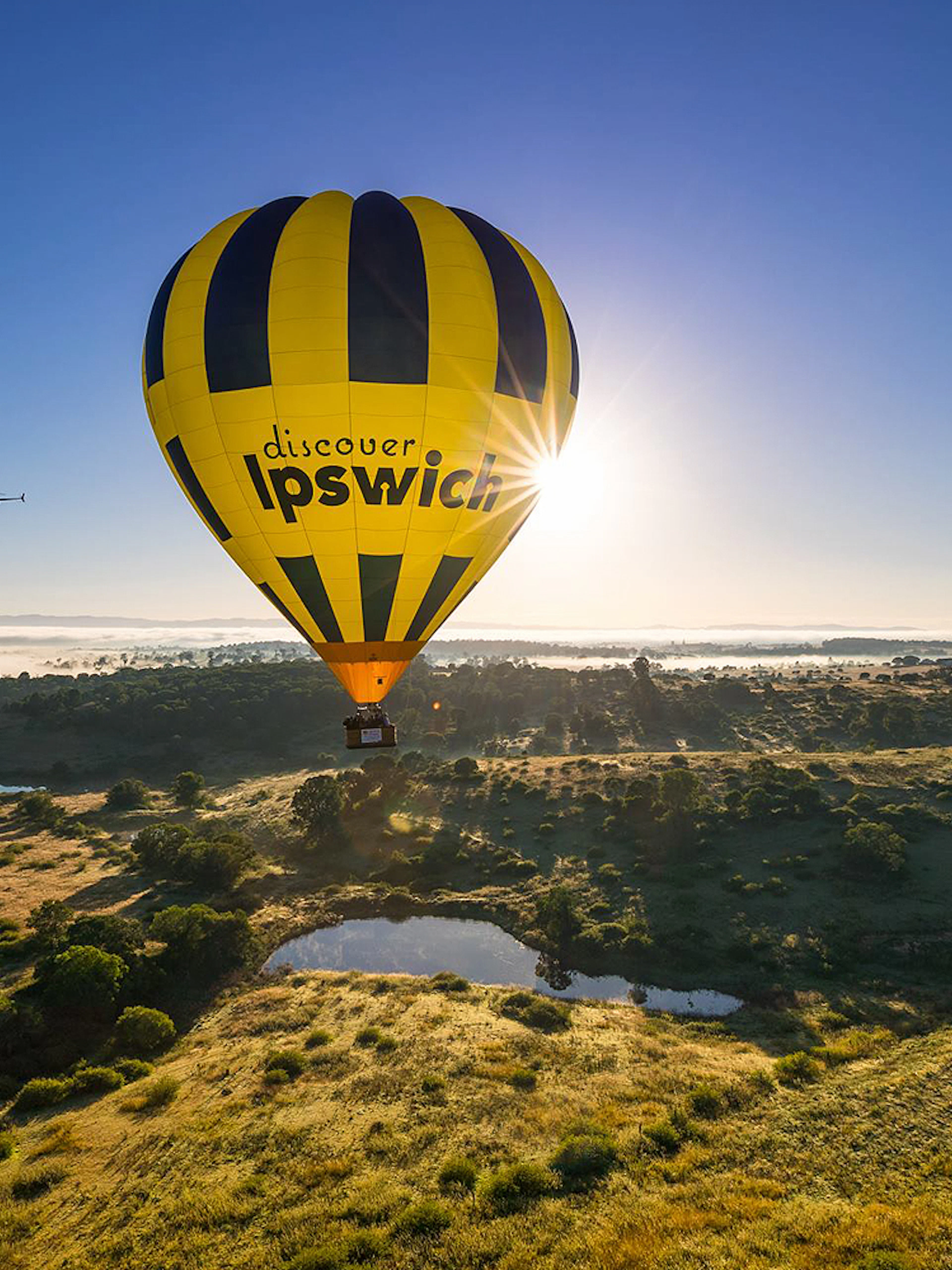 Hot air balloon over Ipswich landscape during Greater Brisbane flight.