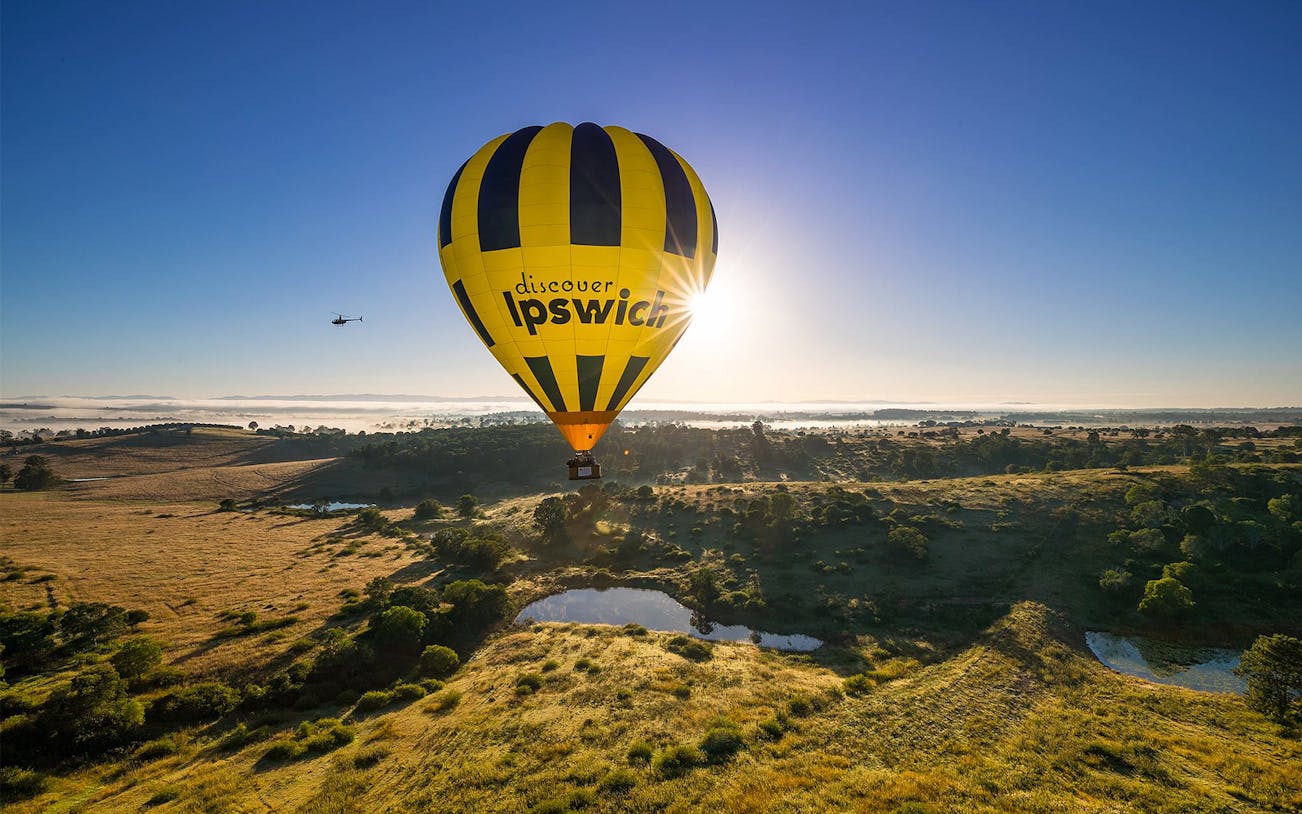 Hot air balloon over Ipswich landscape during Greater Brisbane flight.